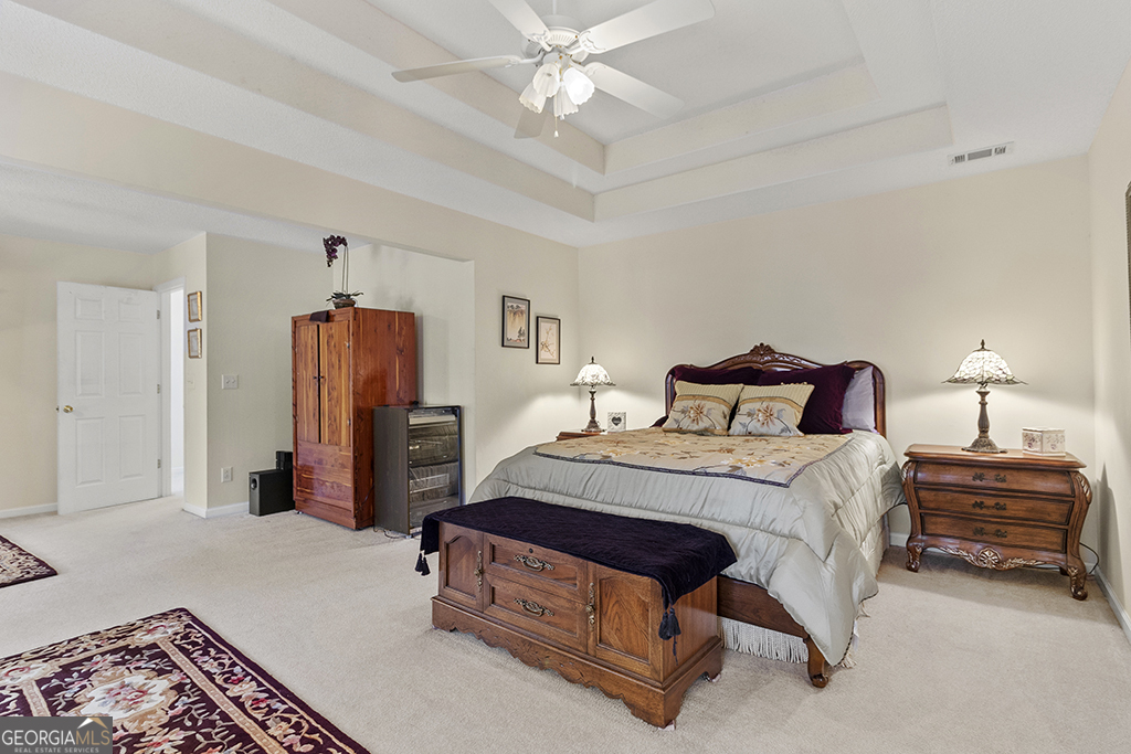 643 Millrun Court Macon, GA 31210 - Photo 20 of 32 a bedroom with a bed and a chandelier