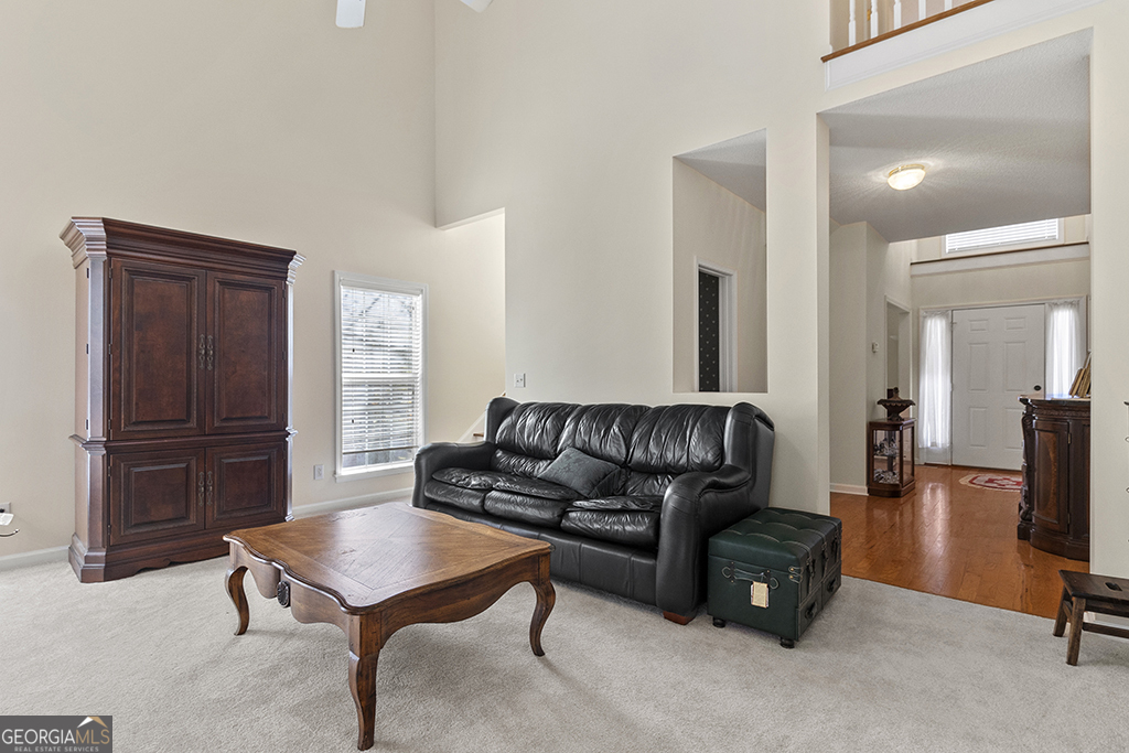 643 Millrun Court Macon, GA 31210 - Photo 10 of 32 a living room with furniture and a refrigerator