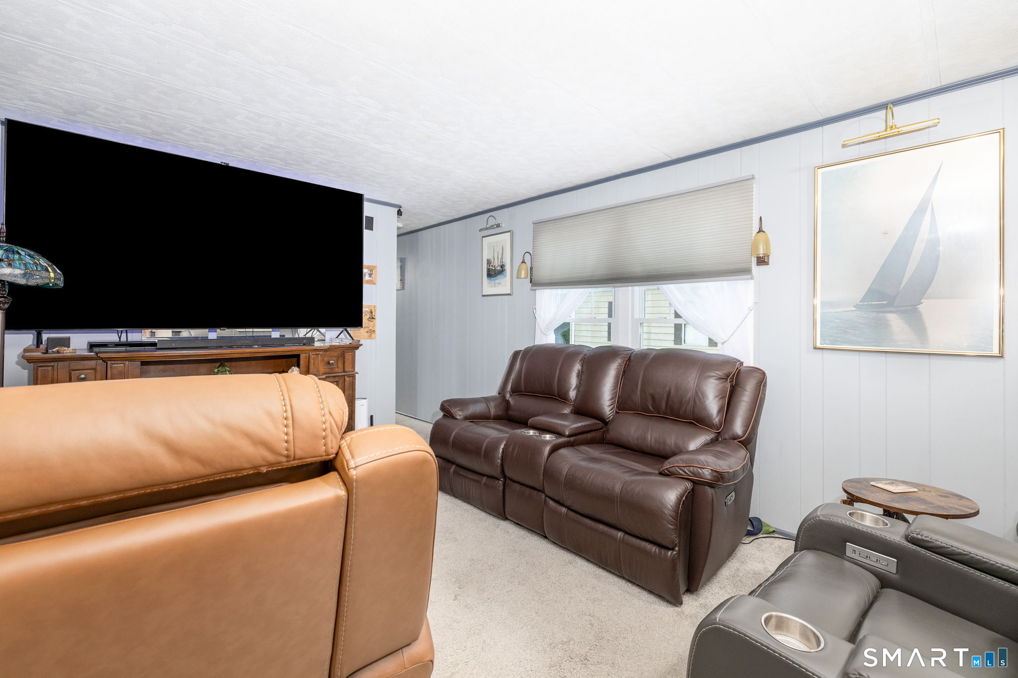 301 Buddington Road Groton, CT 06340 - Photo 13 of 34 a living room with furniture and a flat screen tv
