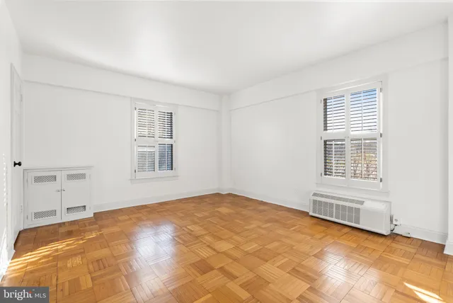 a view of a bedroom with a bed and a window