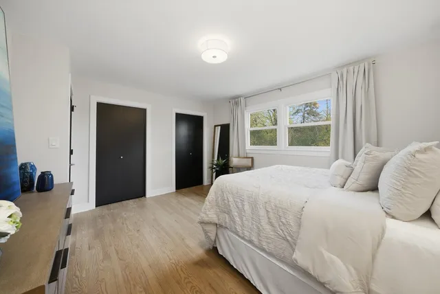 a bedroom with a large bed and a dresser