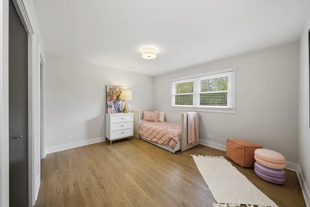 a spacious bedroom with a bed and a window