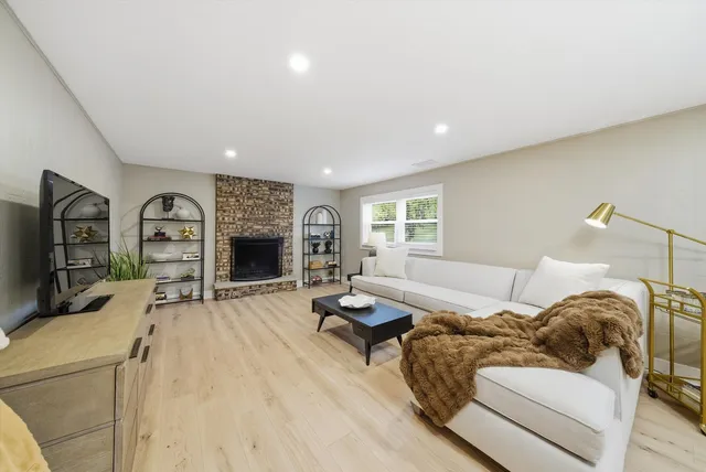 a living room with furniture and a fireplace