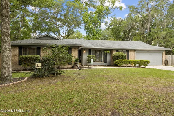 a view of a house with backyard porch and sitting area