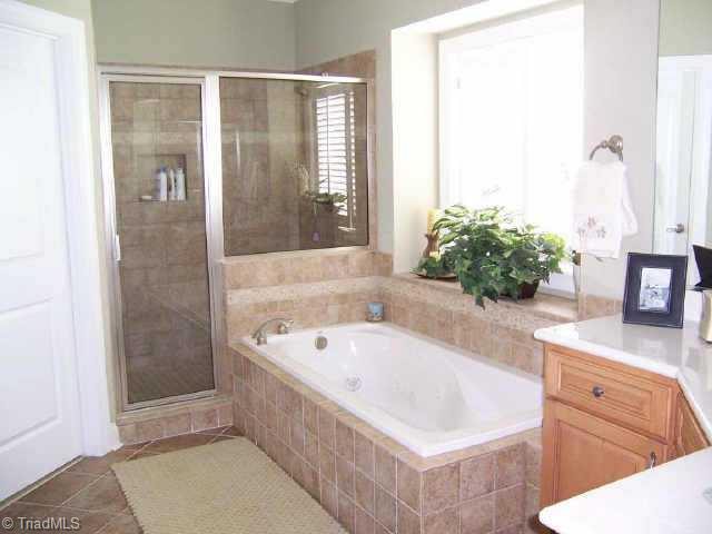 7079 Lanier Road Summerfield, NC 27358 - Photo 3 of 7 Other. Oversized Shower with dual showerheads His & Her Vanities Whirlpool Tub