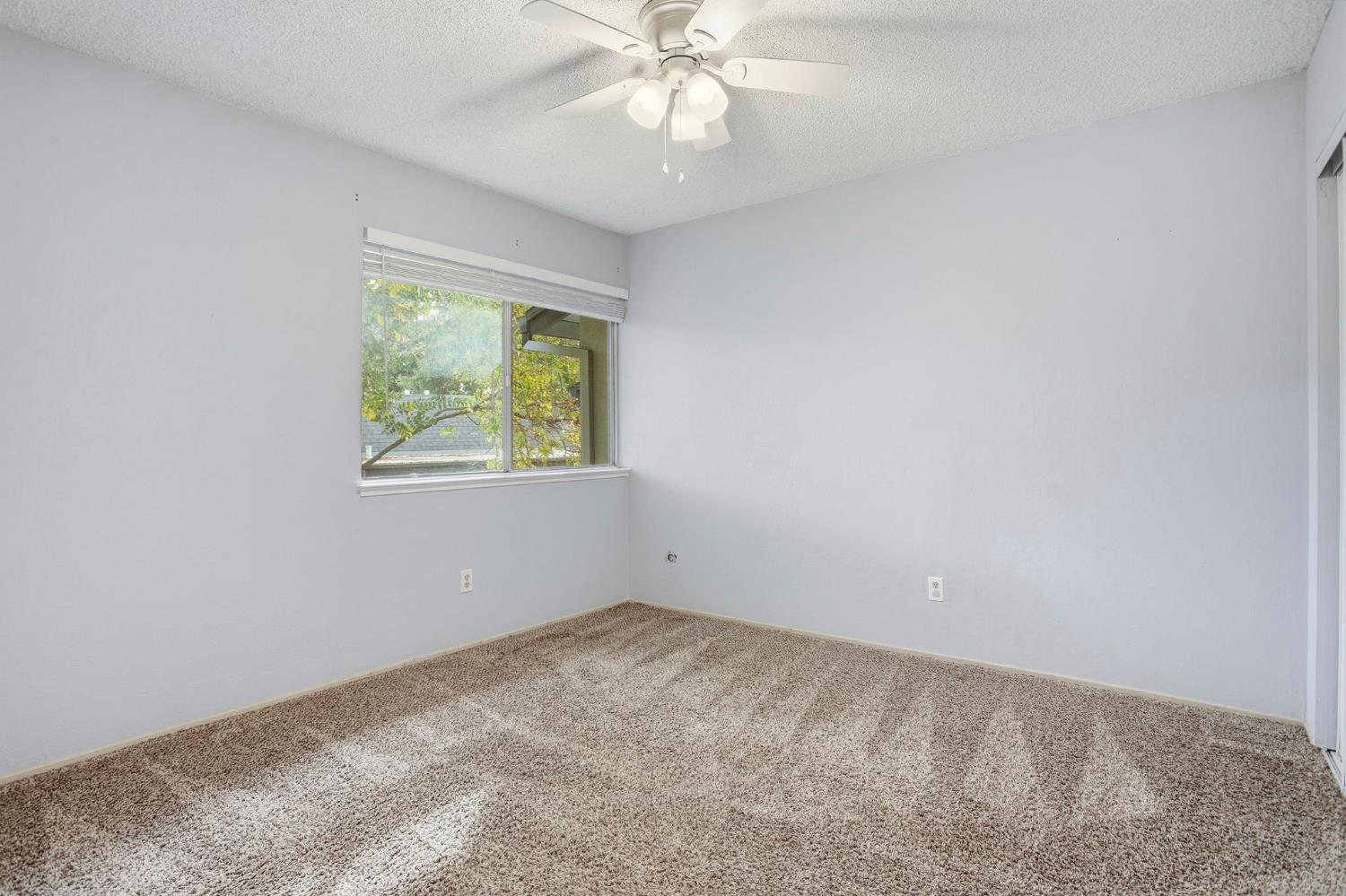 5805 Muldrow Road Sacramento, CA 95841 - Photo 18 of 27 Second floor bedroom featuring carpet, a textured ceiling, and a ceiling fan