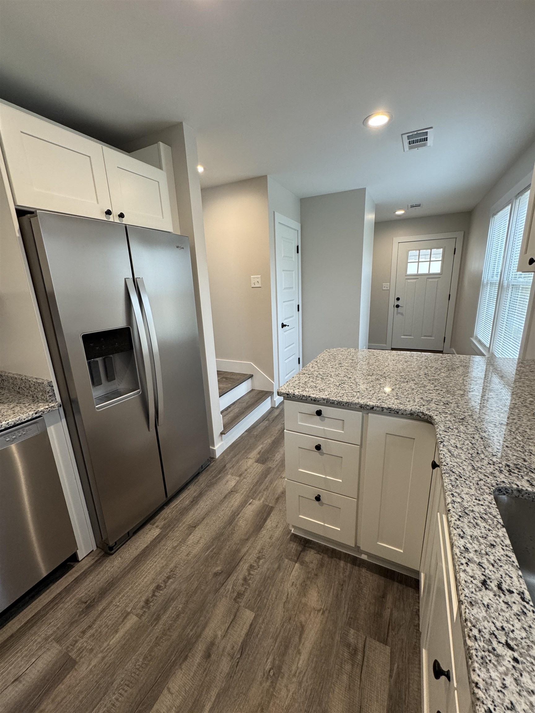 311 East Ripley Avenue Covington, TN 38019 - Photo 12 of 37 Kitchen featuring white cabinets, stainless steel appliances, light granite counters, dark wood-type flooring, and recessed lighting