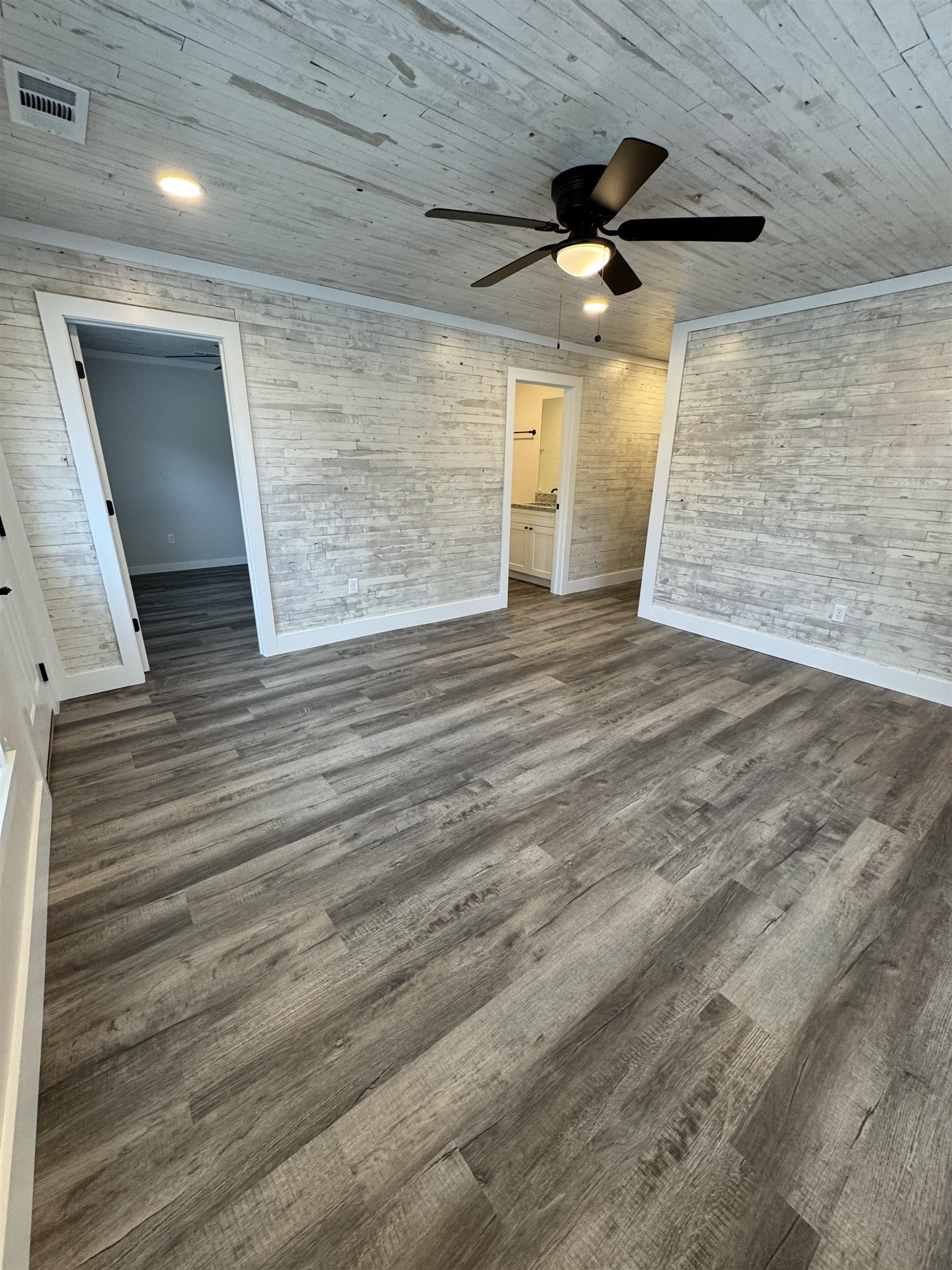 311 East Ripley Avenue Covington, TN 38019 - Photo 2 of 37 Unfurnished living room with dark wood-style floors and ceiling fan