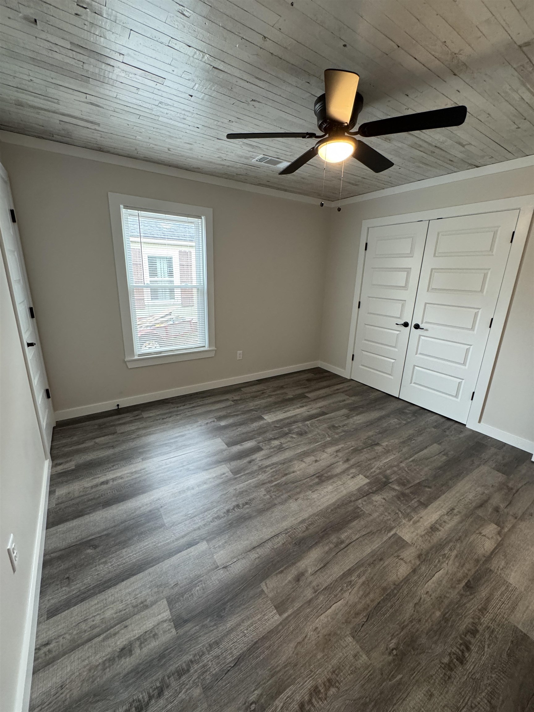 311 East Ripley Avenue Covington, TN 38019 - Photo 26 of 37 an empty room with wooden floor and windows
