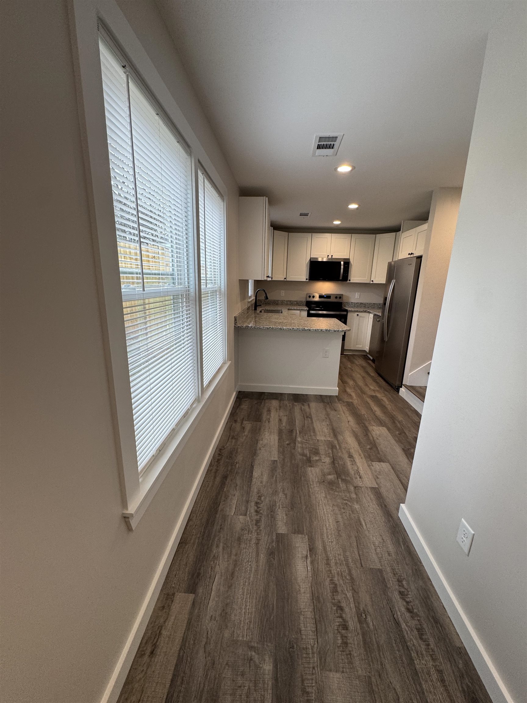 311 East Ripley Avenue Covington, TN 38019 - Photo 29 of 37 a view of kitchen with cabinets and wooden floor