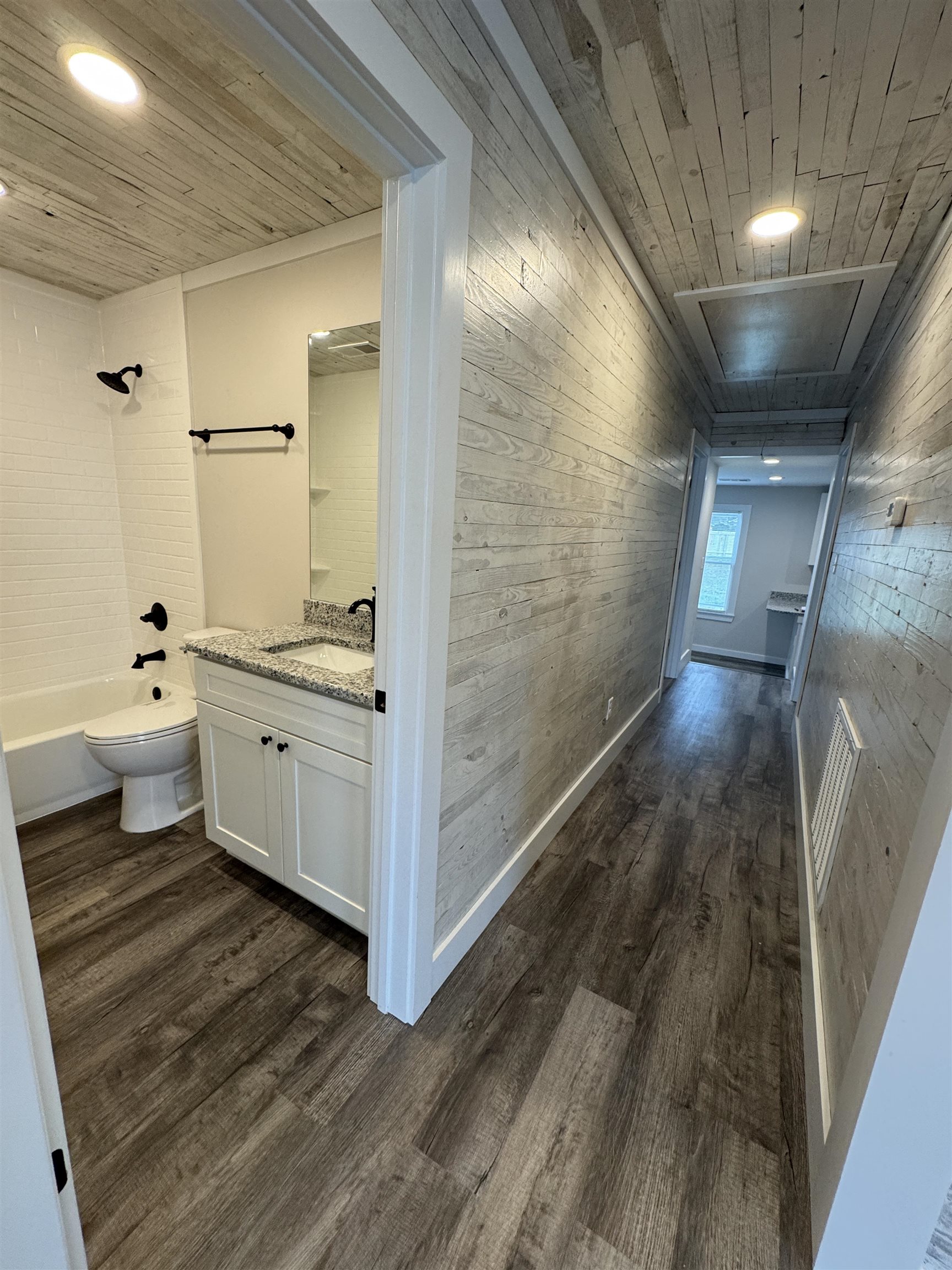 311 East Ripley Avenue Covington, TN 38019 - Photo 4 of 37 Hallway with wood walls, dark wood-style flooring, wooden ceiling, and recessed lighting