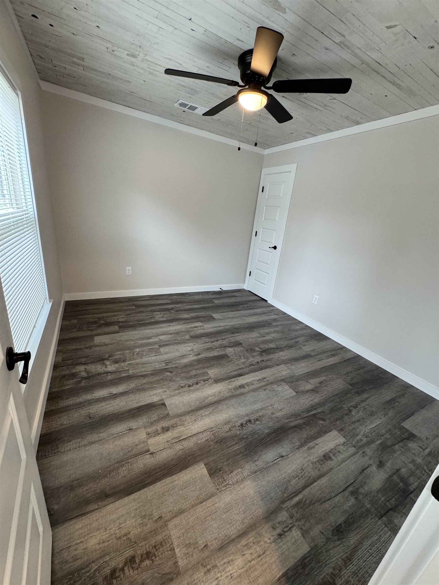 311 East Ripley Avenue Covington, TN 38019 - Photo 5 of 37 Empty room with ceiling fan, crown molding, dark wood finished floors, and wood ceiling