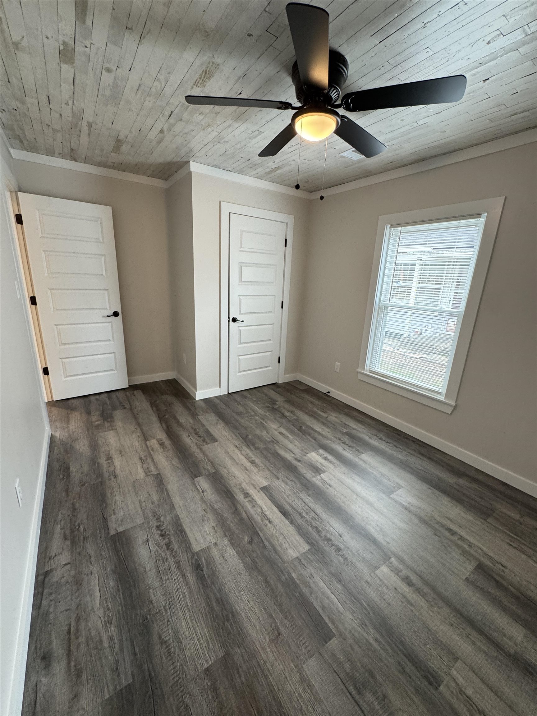 311 East Ripley Avenue Covington, TN 38019 - Photo 9 of 37 Unfurnished bedroom featuring a ceiling fan, dark wood-style flooring, ornamental molding, and wood ceiling