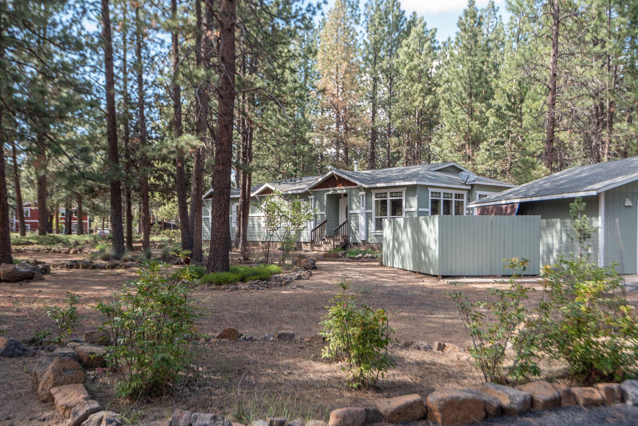 60055 Hopi Road Bend, OR 97702 - Photo 1 of 37 a front view of a house with a garden