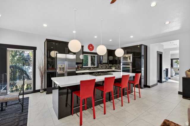 145 Carnesecca Court Mapleton, UT 84664 - Photo 28 of 109 Kitchen with a breakfast bar, plenty of natural light, and a large island