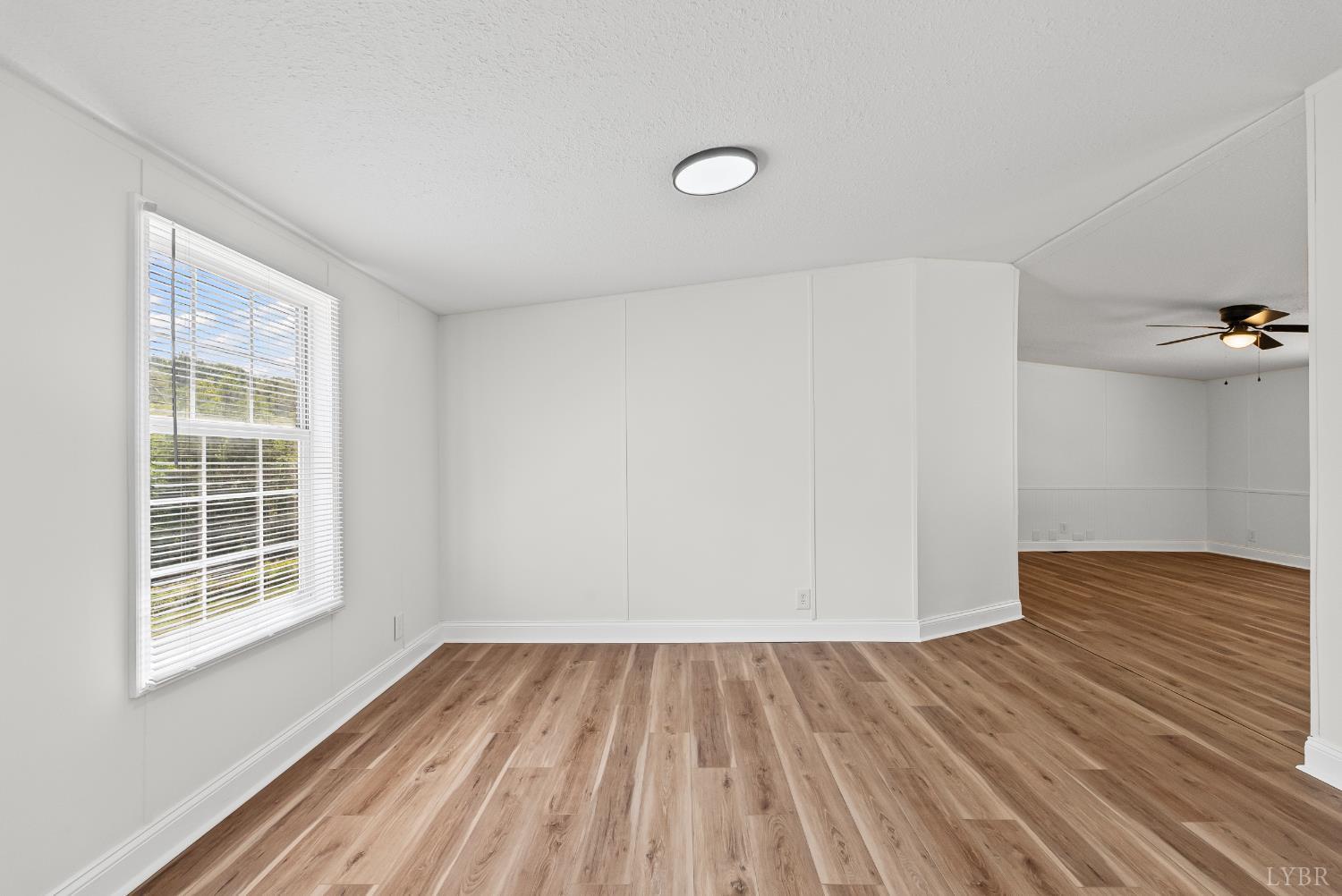397 Dreaming Creek Road Spout Spring, VA 24538 - Photo 11 of 39 an empty room with wooden floor and windows