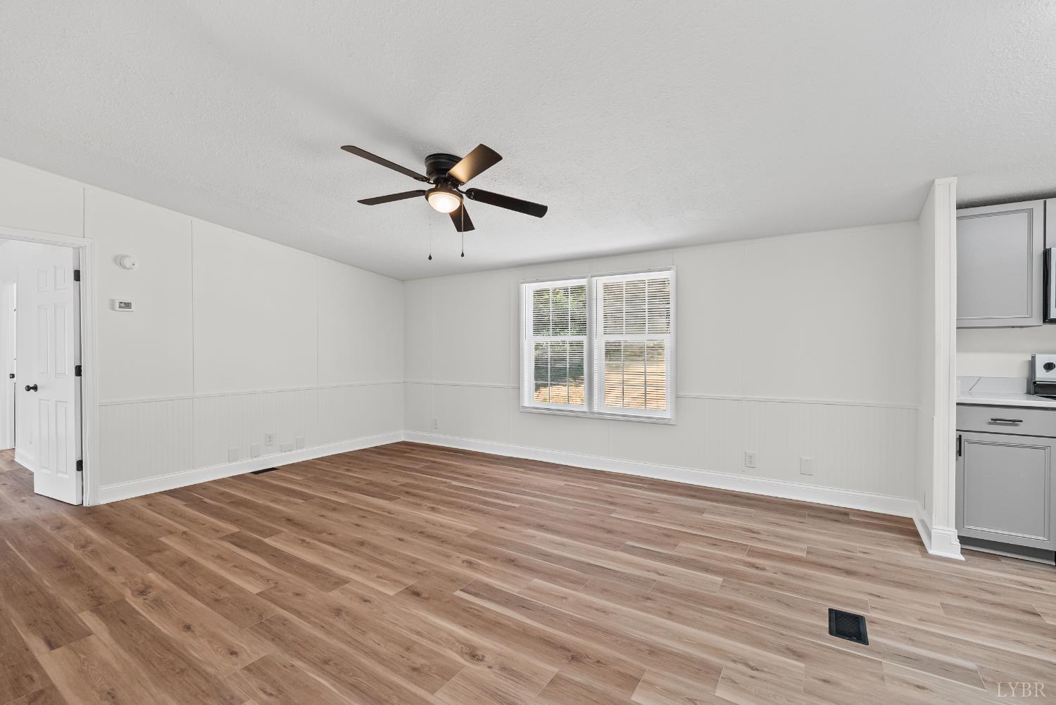 397 Dreaming Creek Road Spout Spring, VA 24538 - Photo 13 of 39 an empty room with wooden floor and windows