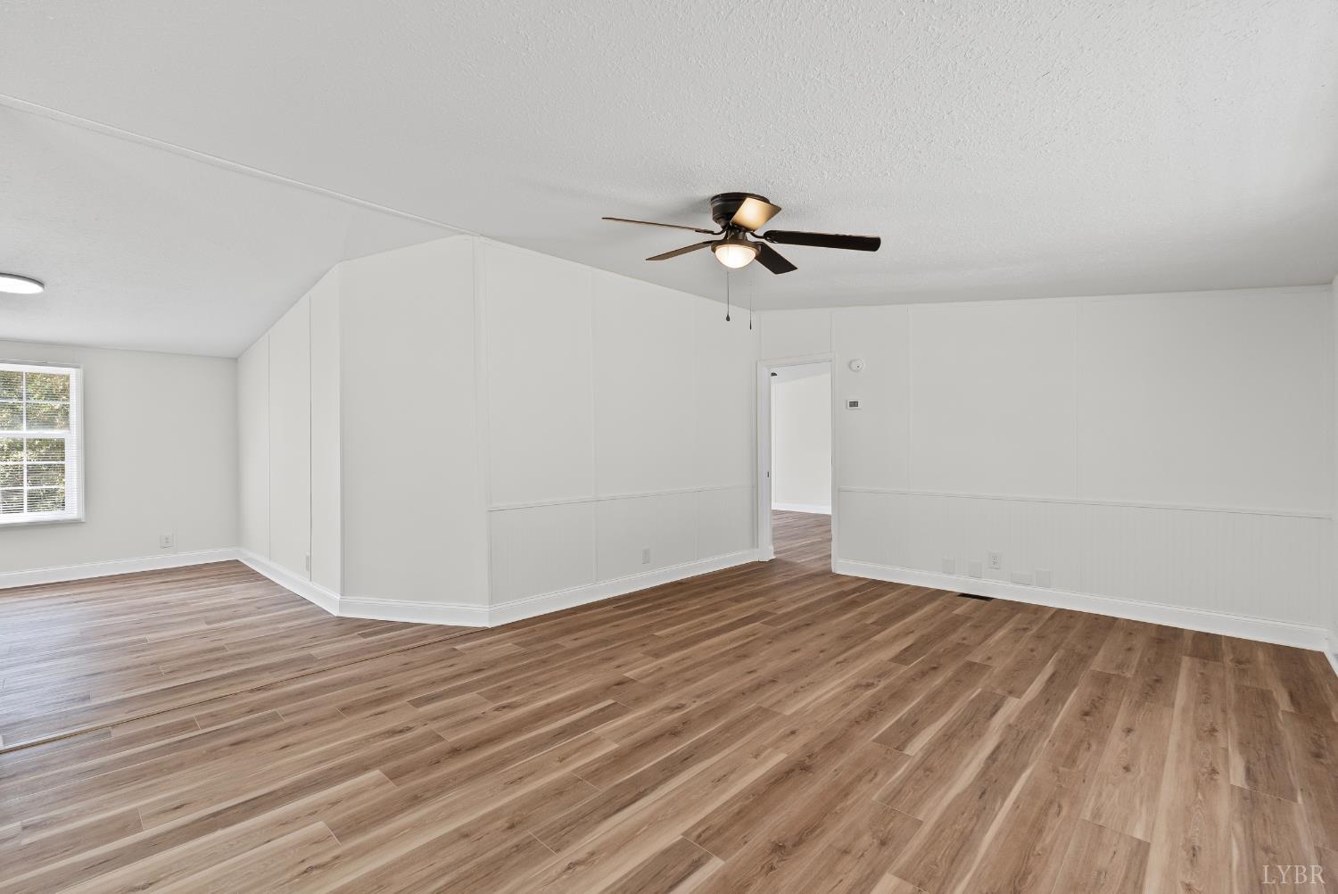 397 Dreaming Creek Road Spout Spring, VA 24538 - Photo 14 of 39 a view of a room with wooden floor and ceiling fan