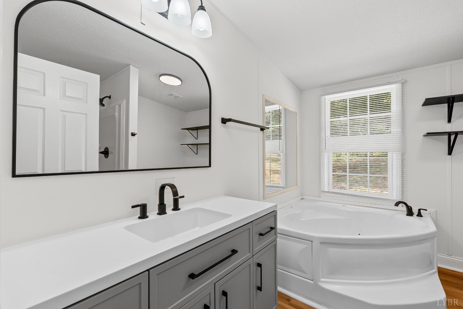 397 Dreaming Creek Road Spout Spring, VA 24538 - Photo 19 of 39 a bathroom with a sink a bathtub and a mirror