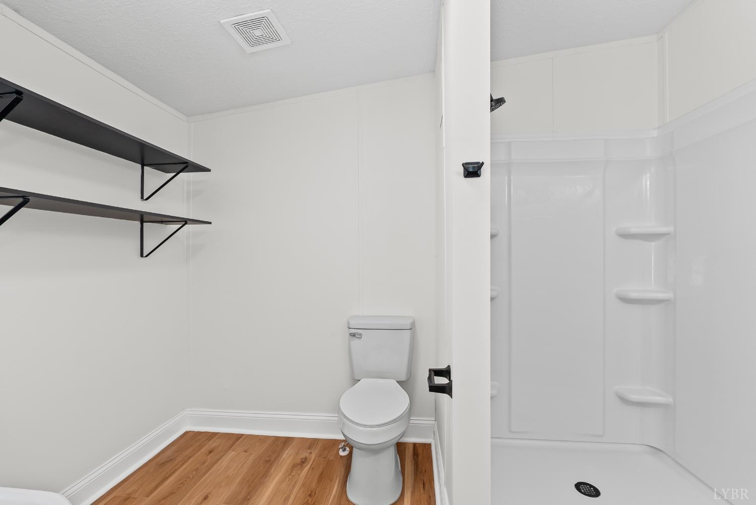 397 Dreaming Creek Road Spout Spring, VA 24538 - Photo 20 of 39 a bathroom with a granite countertop toilet and a sink