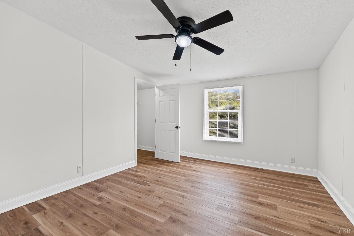 397 Dreaming Creek Road Spout Spring, VA 24538 - Photo 24 of 39 a view of an empty room with wooden floor and a window
