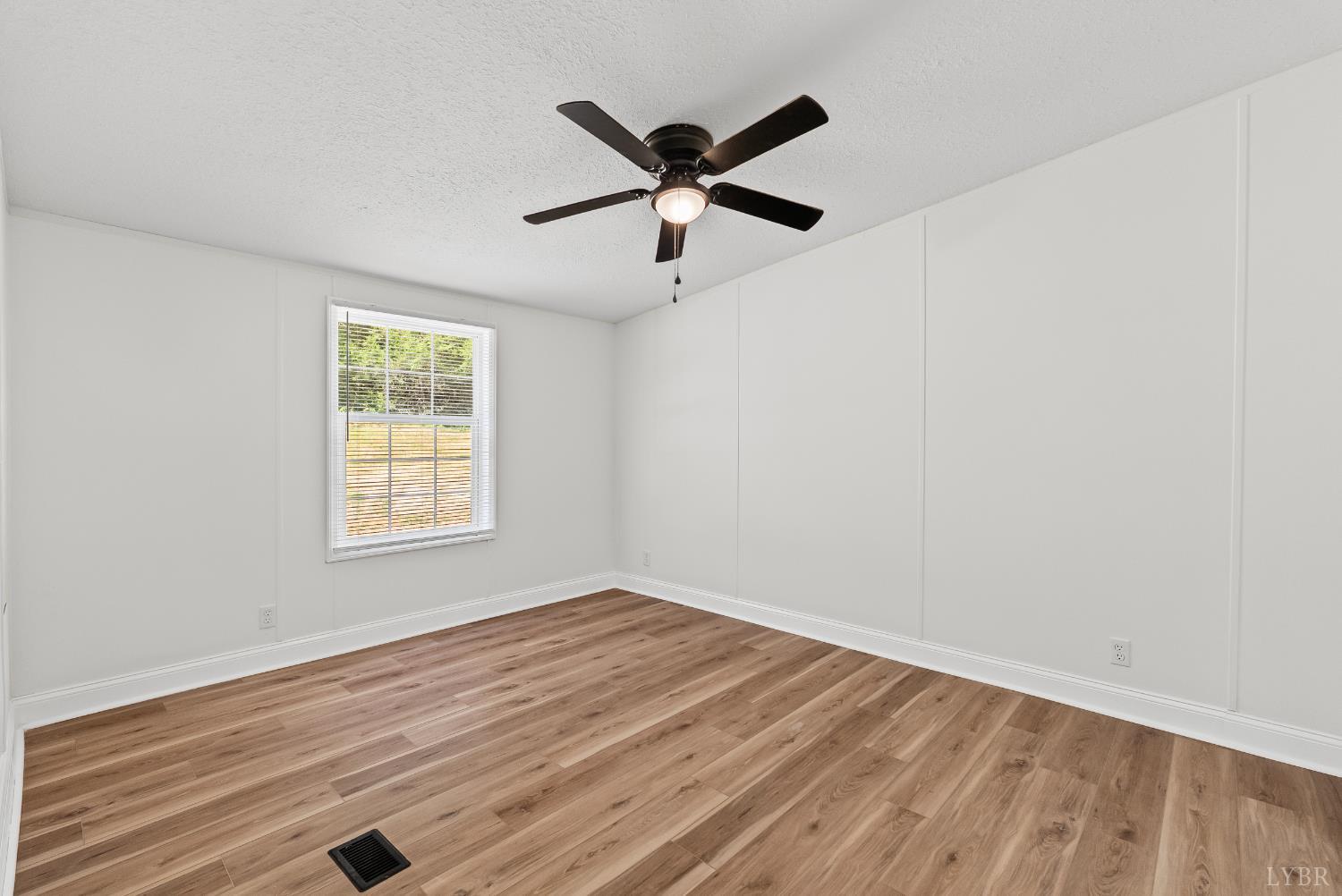 397 Dreaming Creek Road Spout Spring, VA 24538 - Photo 26 of 39 an empty room with wooden floor and ceiling fan