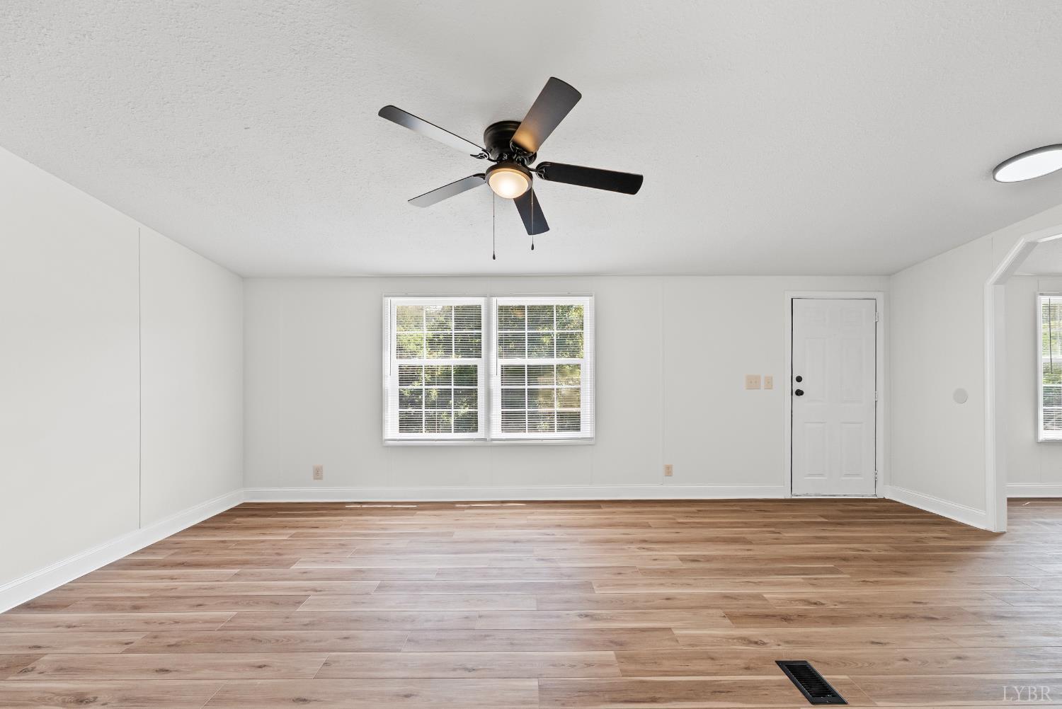 397 Dreaming Creek Road Spout Spring, VA 24538 - Photo 3 of 39 a view of an empty room with wooden floor and a window