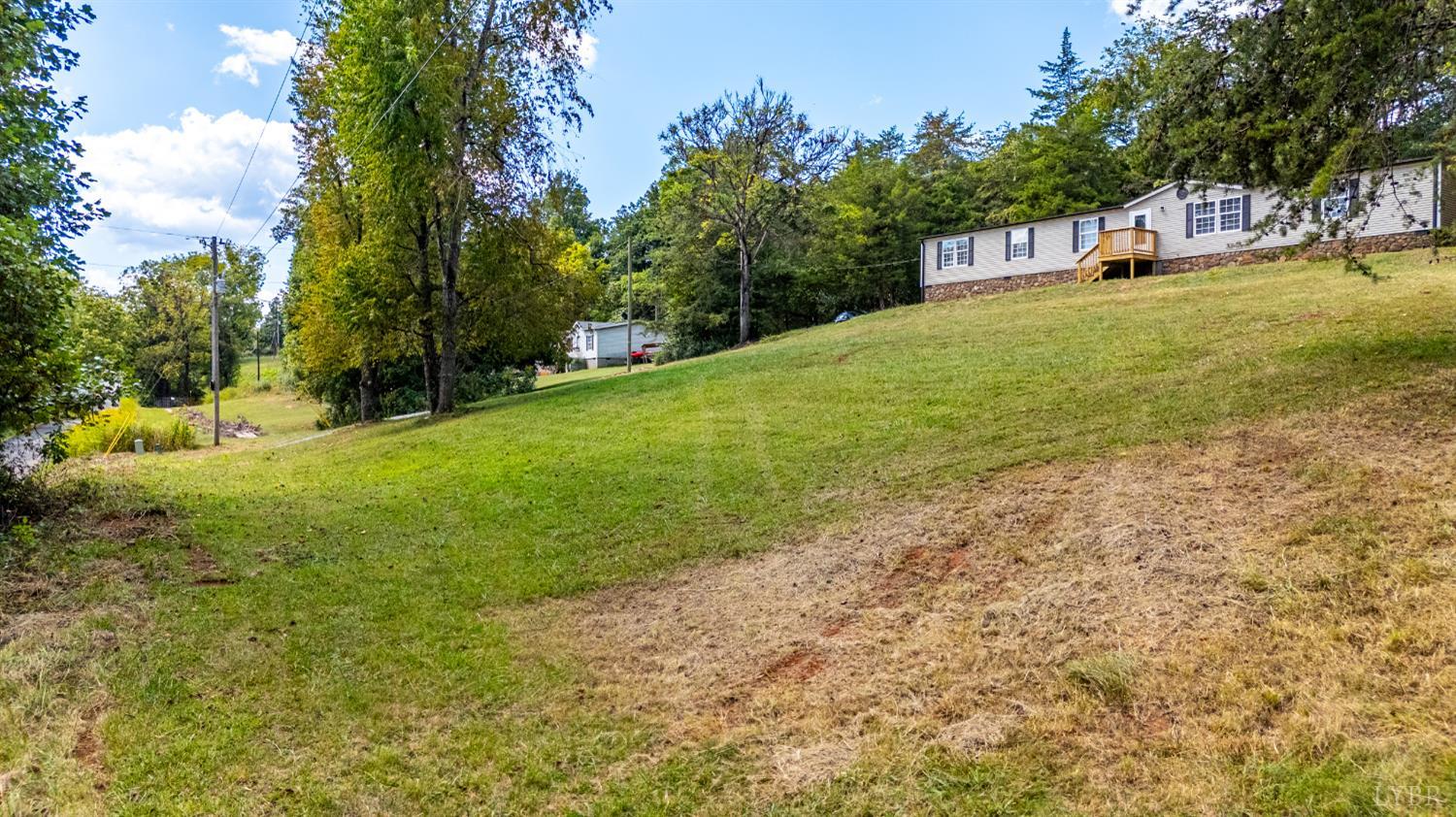 397 Dreaming Creek Road Spout Spring, VA 24538 - Photo 34 of 39 a view of a yard with a house and large trees