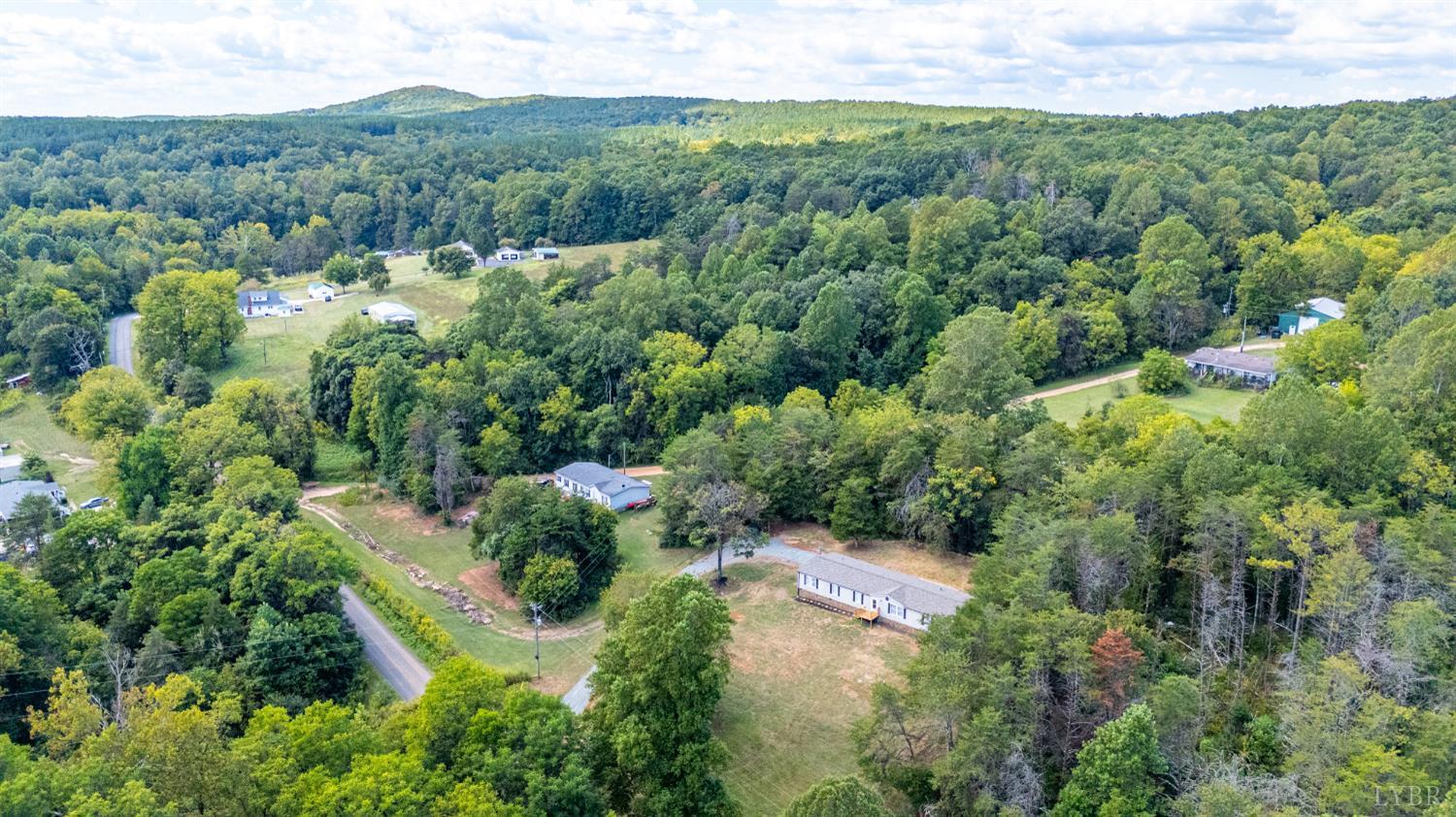 397 Dreaming Creek Road Spout Spring, VA 24538 - Photo 38 of 39 an aerial view of residential houses with outdoor space and trees all around