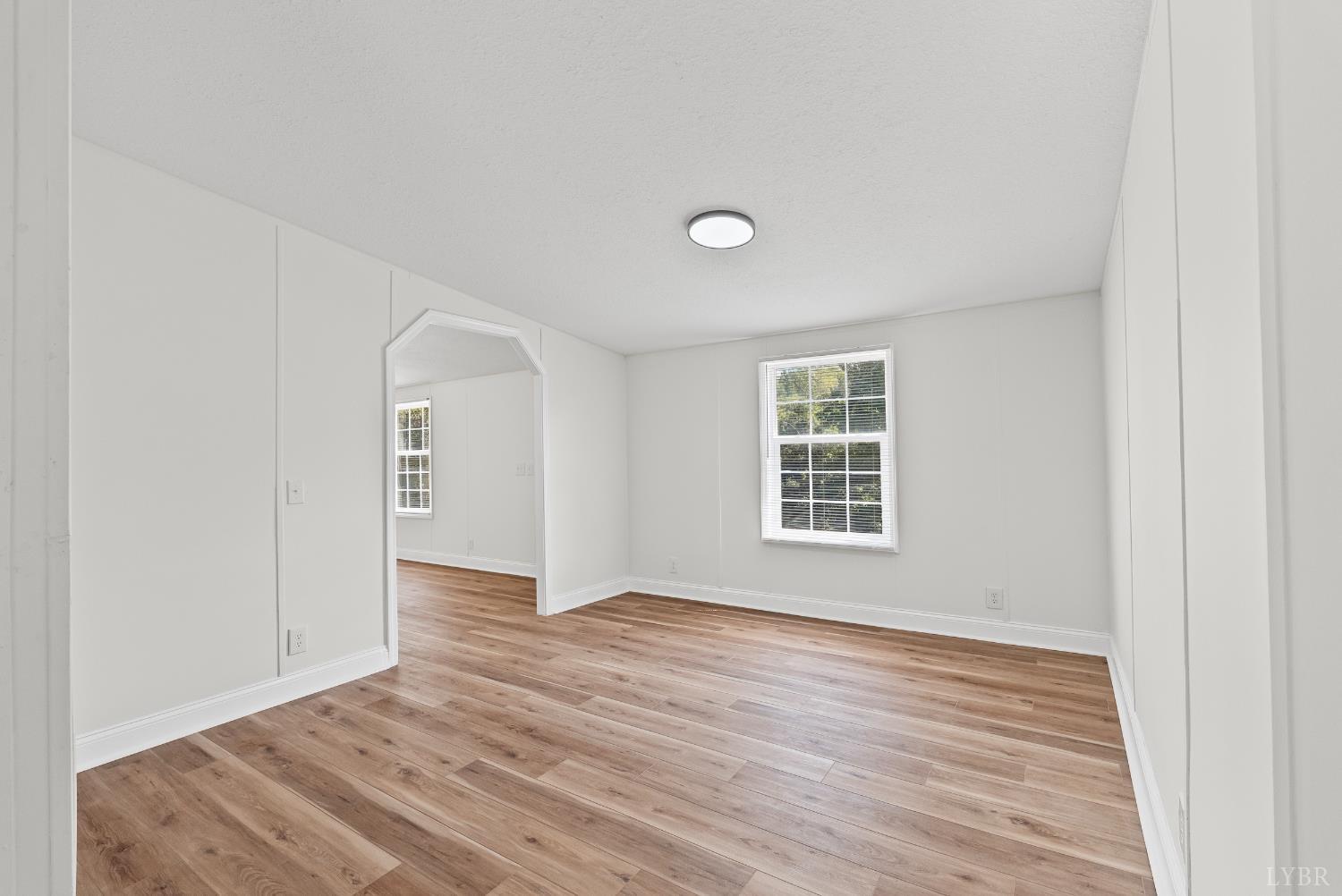 397 Dreaming Creek Road Spout Spring, VA 24538 - Photo 10 of 39 a view of an empty room with wooden floor and a window