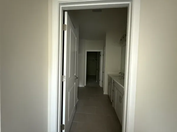 a view of a hallway with wooden shelves
