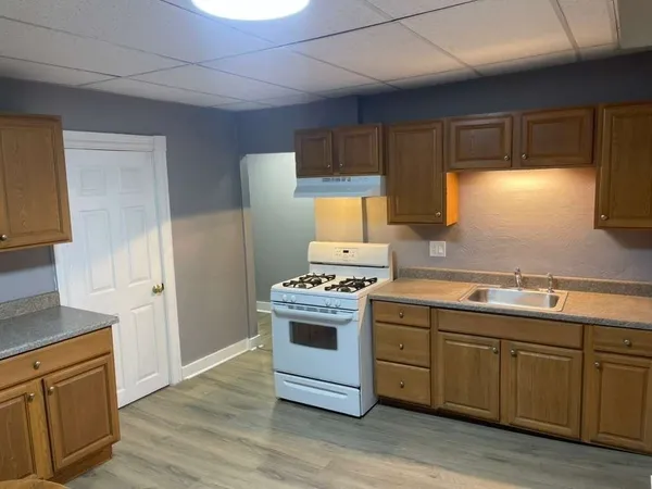 a kitchen with stainless steel appliances a stove a sink and a refrigerator