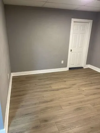 a view of an empty room and wooden floor
