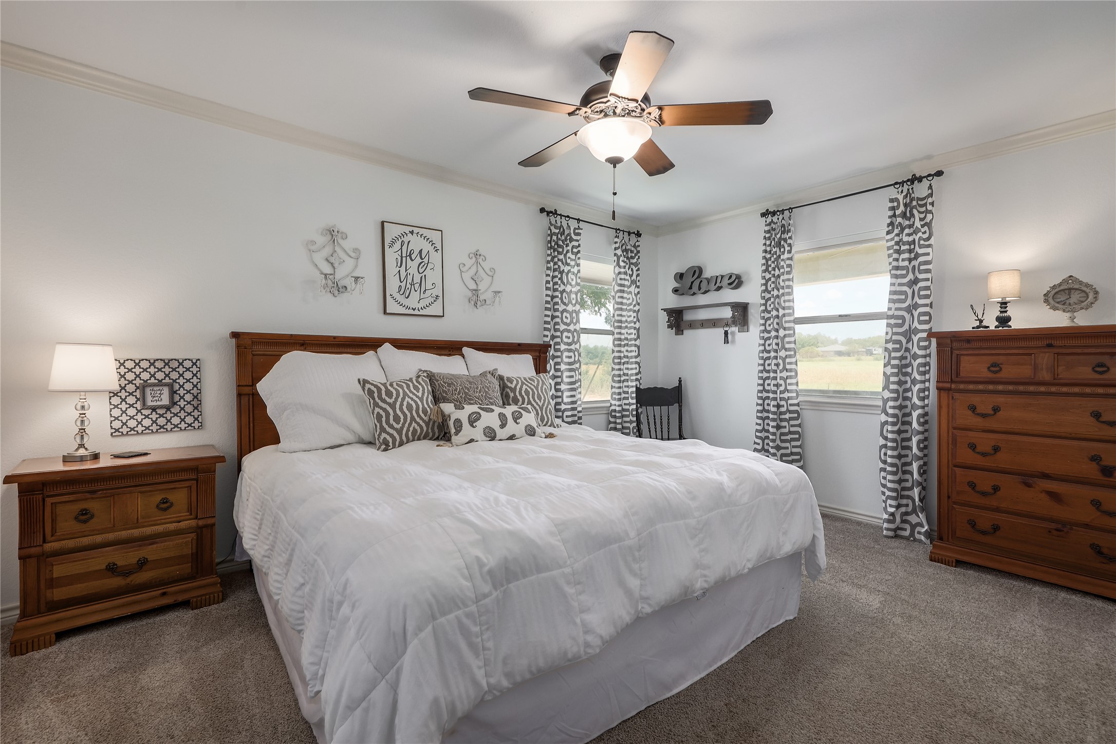 525 Ellen Williams Loop Kingsland, TX 78639 - Photo 25 of 36 a bedroom with a bed and a chandelier