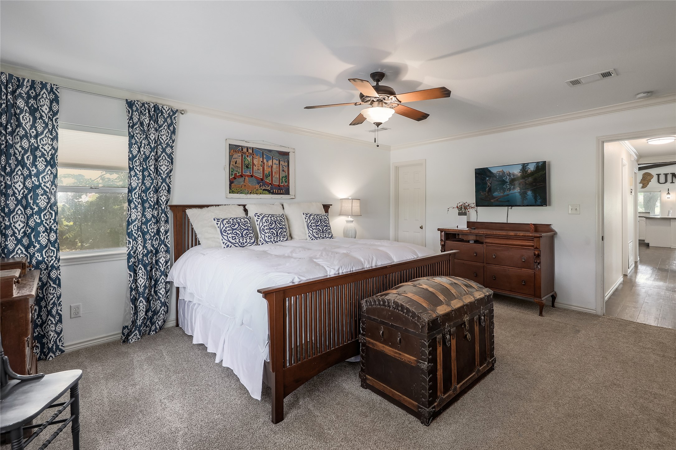 525 Ellen Williams Loop Kingsland, TX 78639 - Photo 26 of 36 a spacious bedroom with a bed and a chandelier