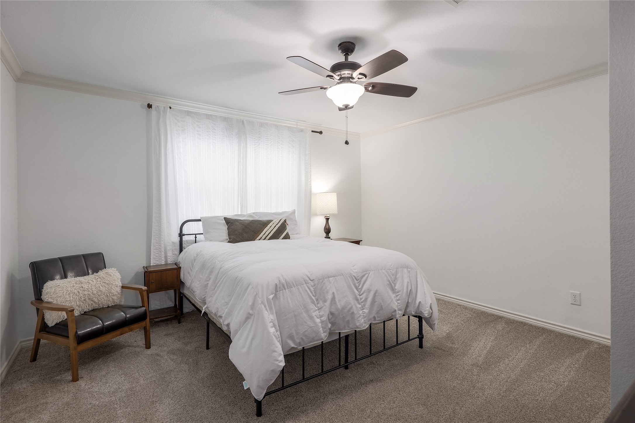 525 Ellen Williams Loop Kingsland, TX 78639 - Photo 27 of 36 a bedroom with a bed and a chandelier
