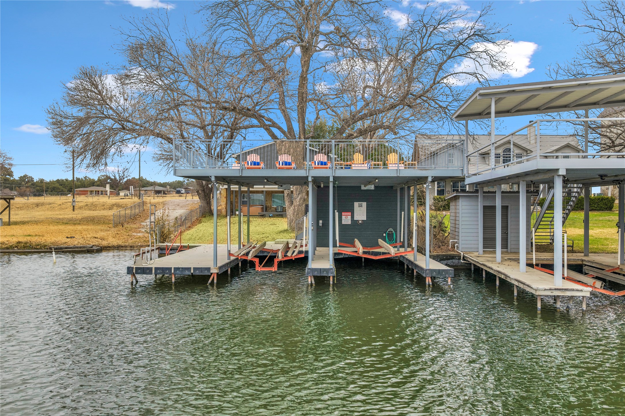 525 Ellen Williams Loop Kingsland, TX 78639 - Photo 34 of 36 a view of a swimming pool with lawn chairs under an umbrella
