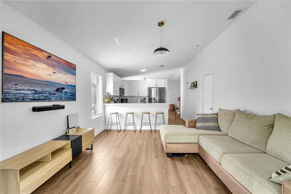 a living room with furniture and a large window