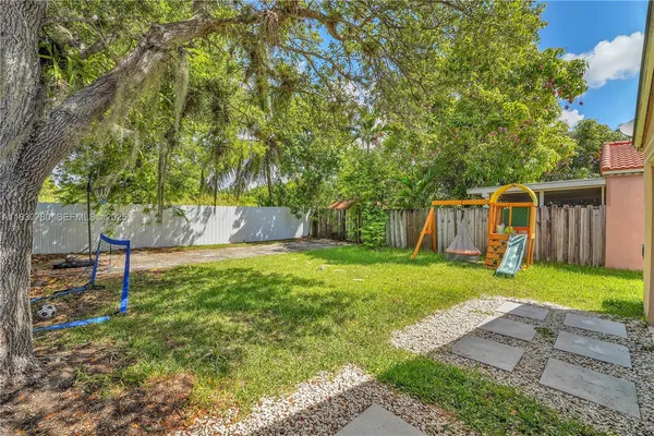 a view of a backyard with large trees