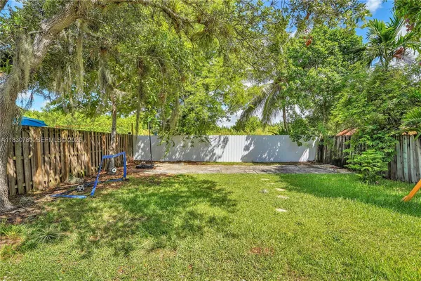 a view of a wooden deck with a tree and wooden fence
