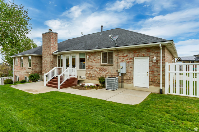 298 North Canyon Road Bountiful, UT 84010 - Photo 53 of 57 Brick exterior with a dark shingle roof, featuring a brick chimney and white trim