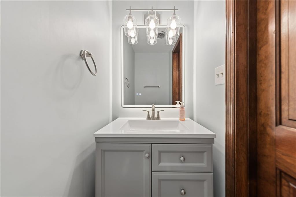 22 Buzzardtown Road Irwin, PA 15642 - Photo 17 of 44 a bathroom with a sink and a mirror