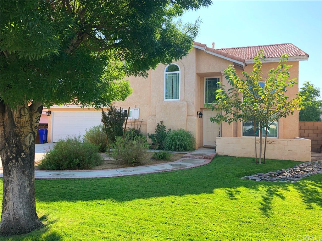 14631 Pony Trail Road Victorville, CA 92392 - Photo 1 of 1 a front view of a house with a yard and trees