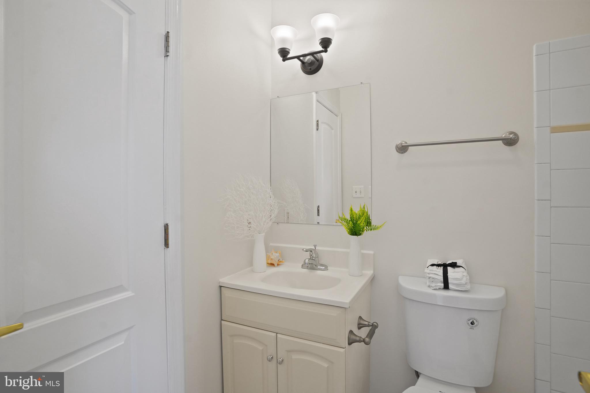 435 Kennedy Street Northwest, Unit 3 Washington, DC 20011 - Photo 7 of 13 a bathroom with a sink a toilet and mirror