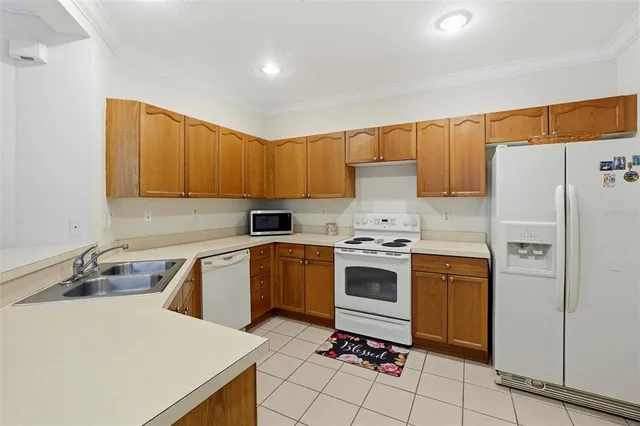 a kitchen with a stove a sink and a refrigerator