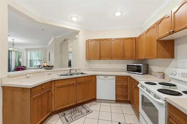 a kitchen with a sink a stove and cabinets