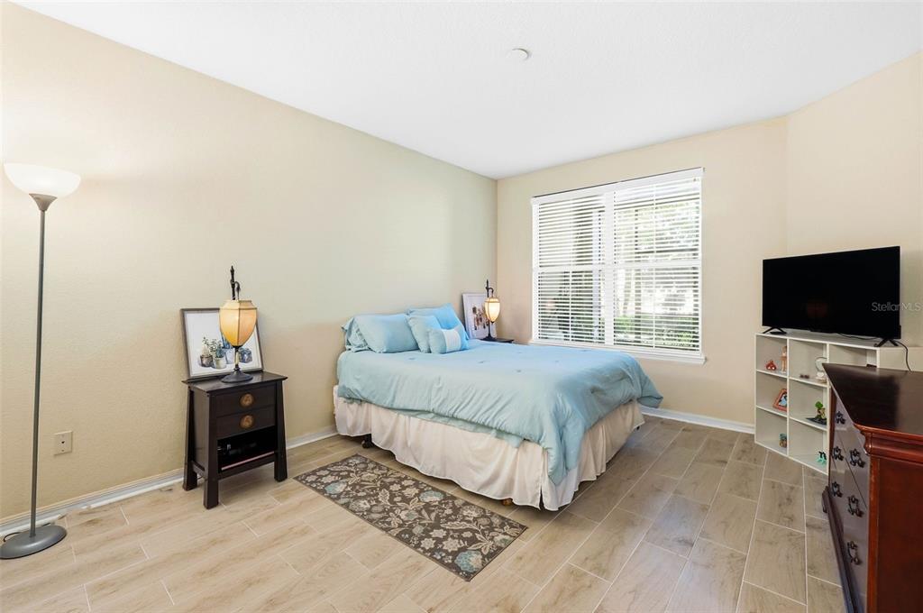 8180 Boat Hook Loop, Unit 304 Windermere, FL 34786 - Photo 22 of 38 a bedroom with a bed and a flat screen tv