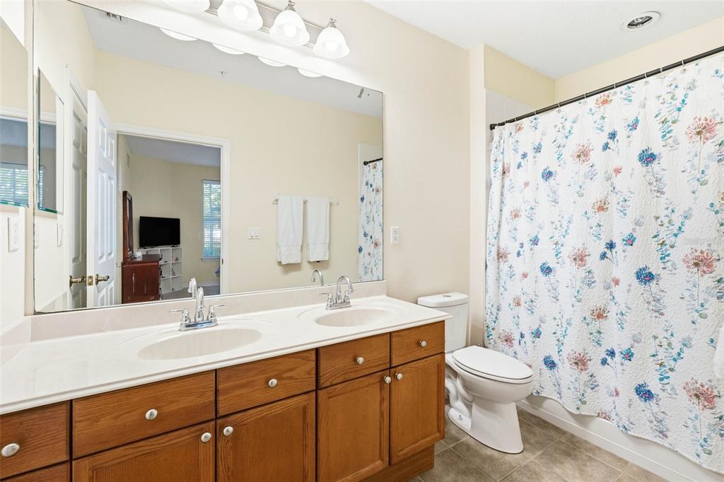 8180 Boat Hook Loop, Unit 304 Windermere, FL 34786 - Photo 24 of 38 a bathroom with a sink a toilet and a mirror