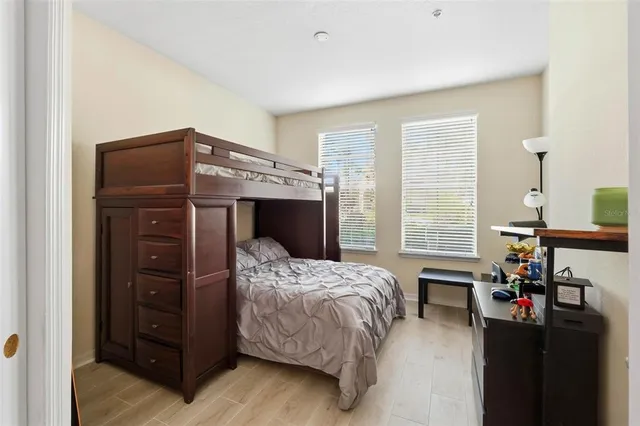 a bedroom with a bed and wooden floor