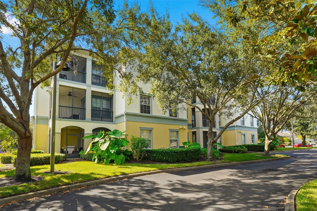 8180 Boat Hook Loop, Unit 304 Windermere, FL 34786 - Photo 30 of 38 a view of a white house with a large tree and plants